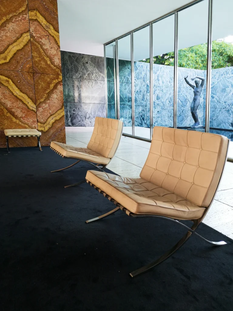 barcelona chairs in a hotel lobby